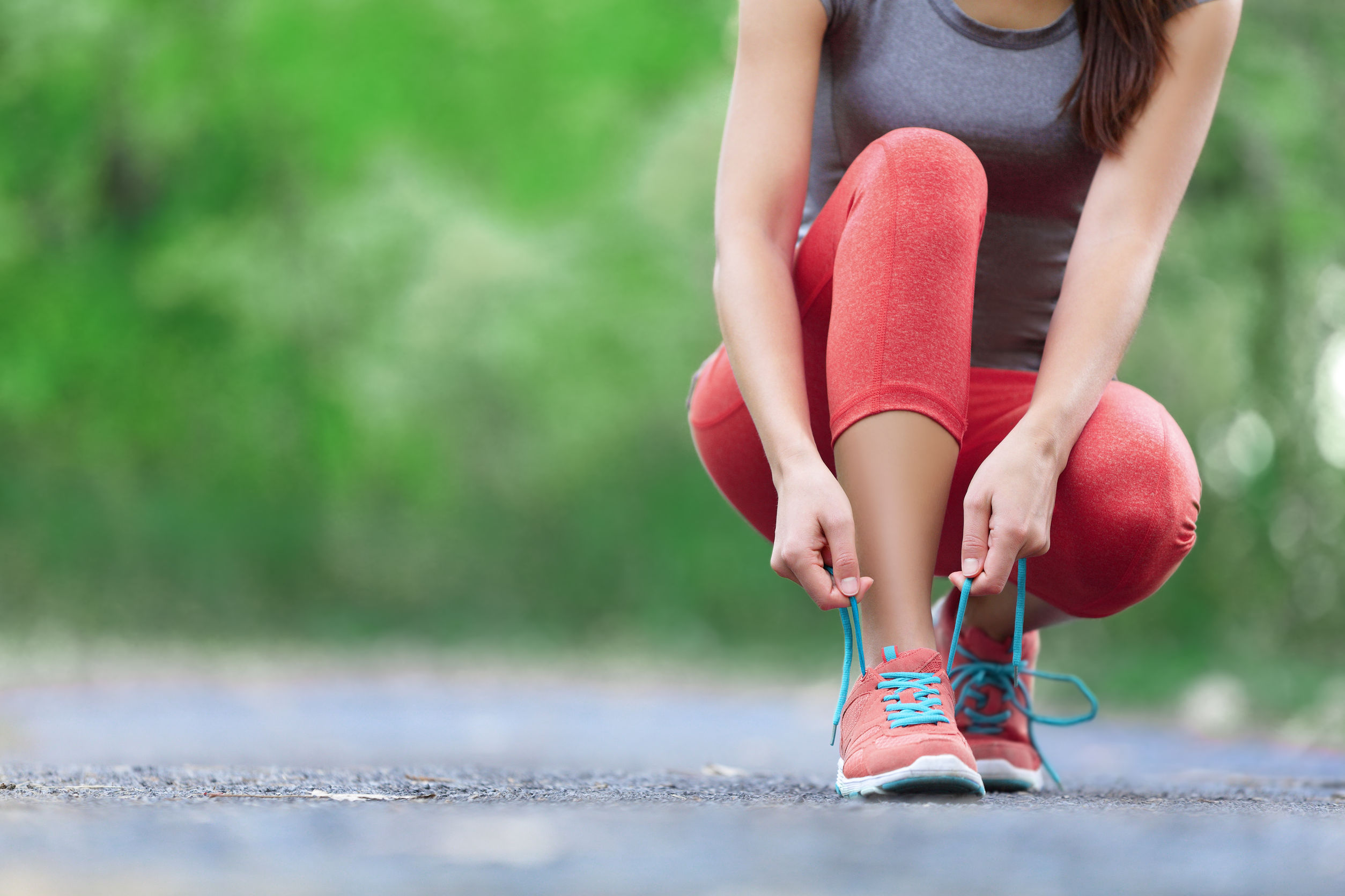 Woman tying running shoes