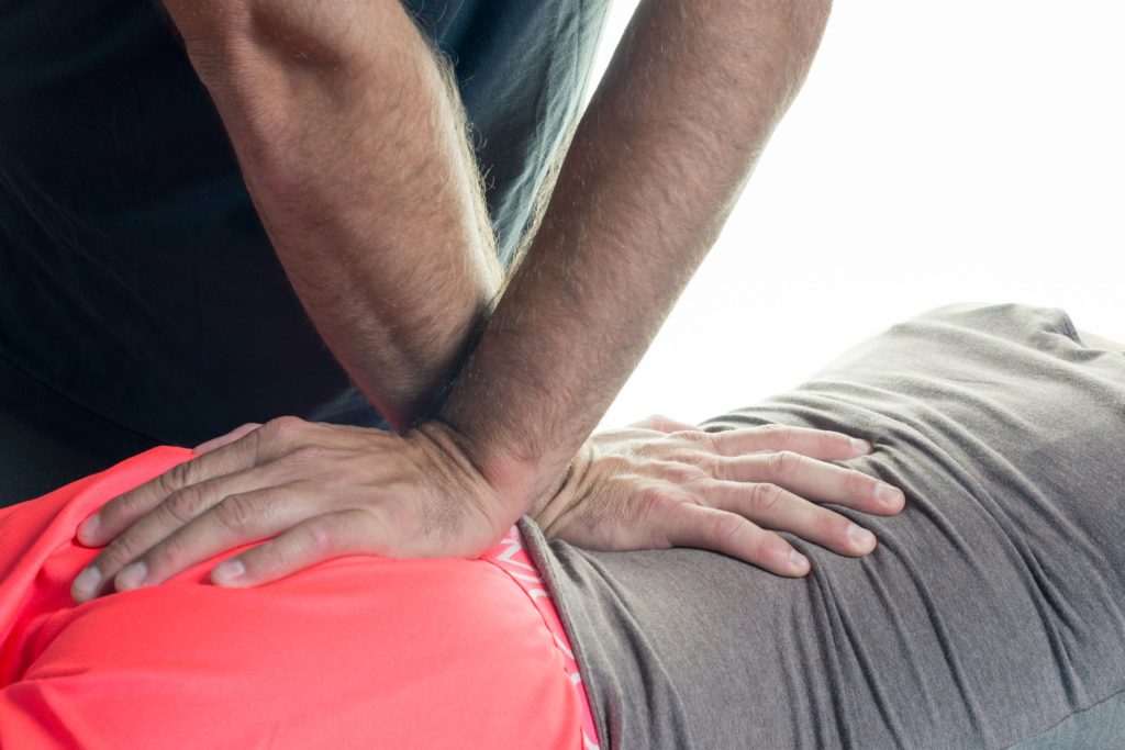 Success Stories - Dynamic Health Carolinas Chiropractic adjustment on an athlete's back