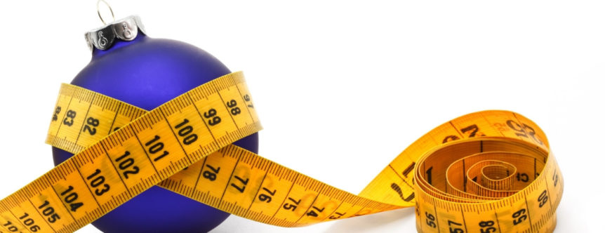 A Christmas ornament with a tape measure around it featured in a blog post about weight loss